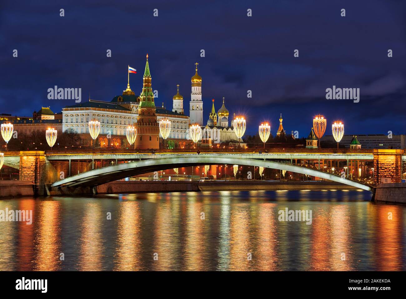 = Christmas Lights of Bolshoy Kamenny Bridge and Moscow Kremlin in Twilight =  Festive view of Bolshoy Kamenny Bridge illuminated with street lights d Stock Photo