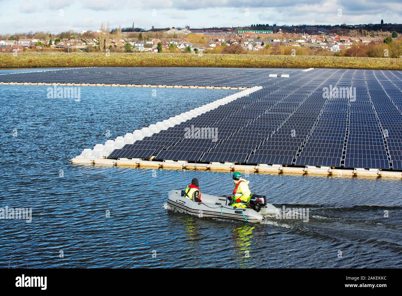 Floating solar farm being grid connected on Godley Reservoir in Hyde, Manchester, England, UK. February 2016 Stock Photo