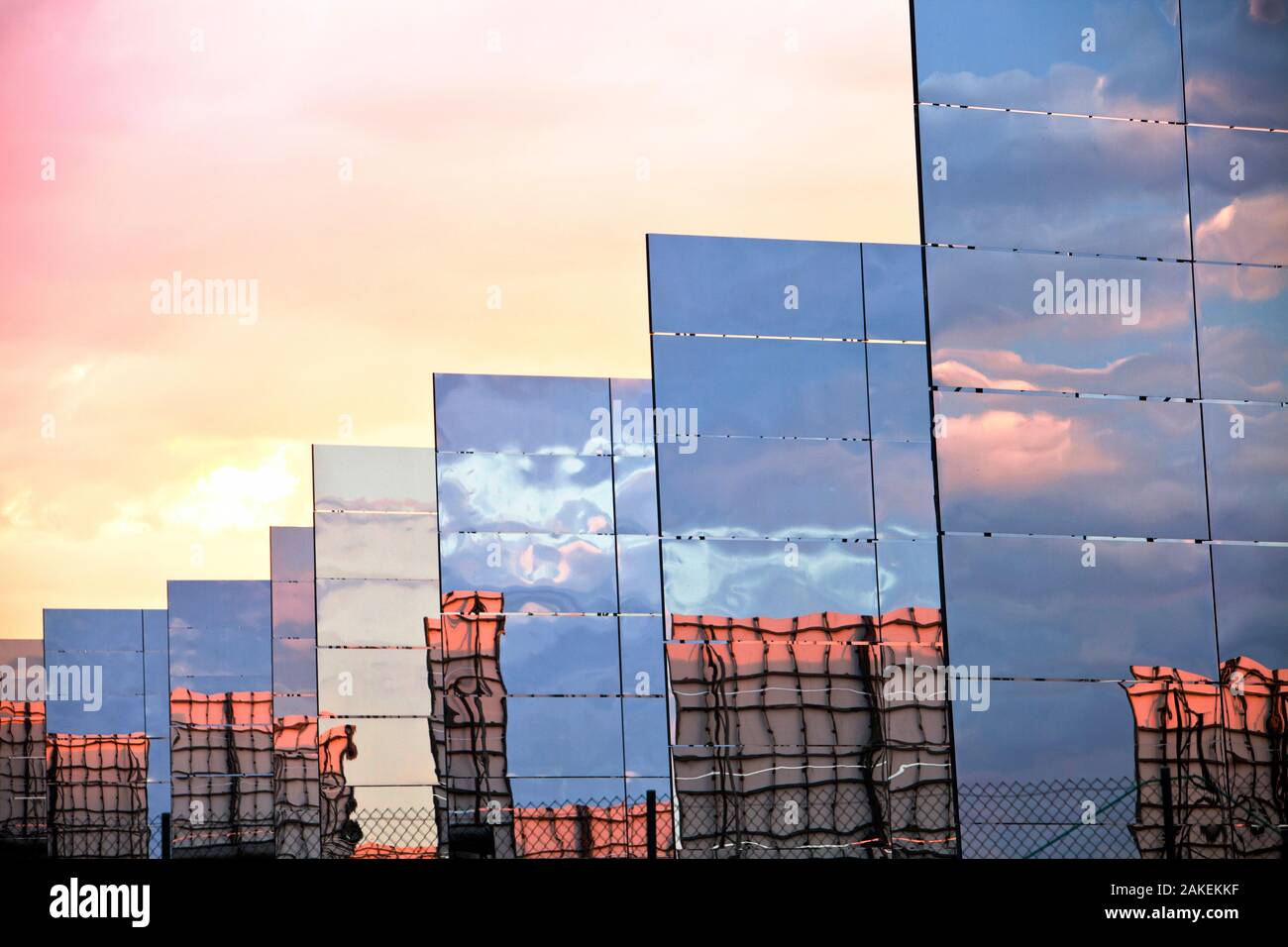 Heliostats, large reflective mirrors directing sunlight to the PS20 solar thermal tower, the only such working solar tower currently in the world. Sanlucar La Mayor, Andalucia, Spain. June 2011 Stock Photo
