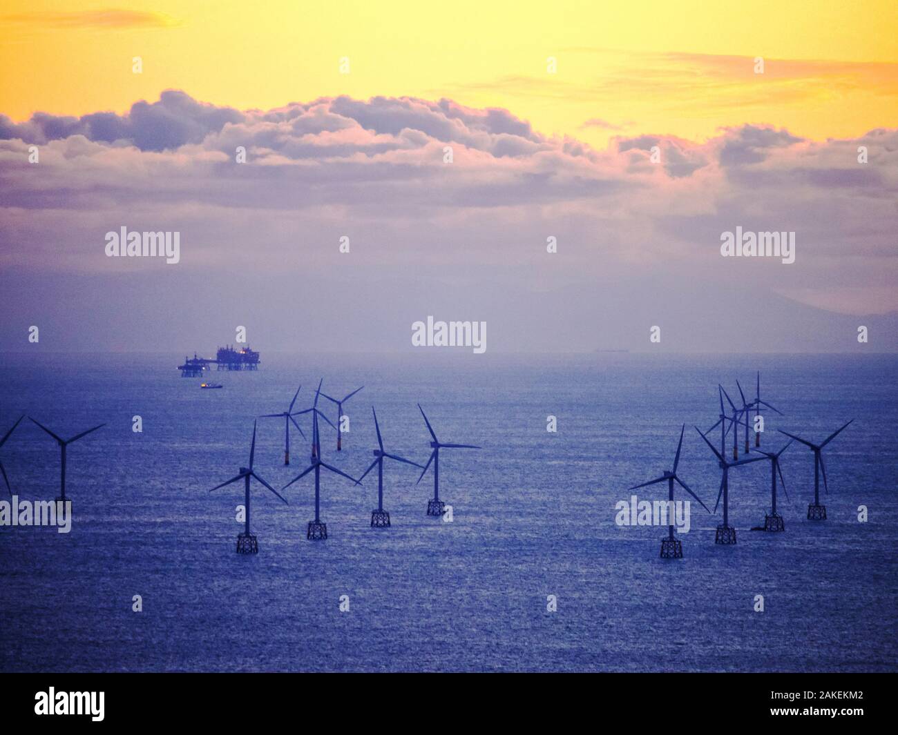 An Irish sea gas platform and wind turbines in the Irish sea from Black Coombe in the Lake district, Cumbria, England, UK. November 2012 Stock Photo