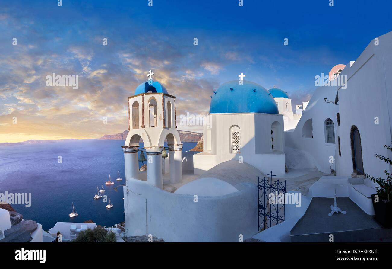 Sunset over the traditional Greek Orthodox churches of Oia (ia), Cyclades Island of  Thira, Santorini, Greece.  The settlement of Oia had been mention Stock Photo