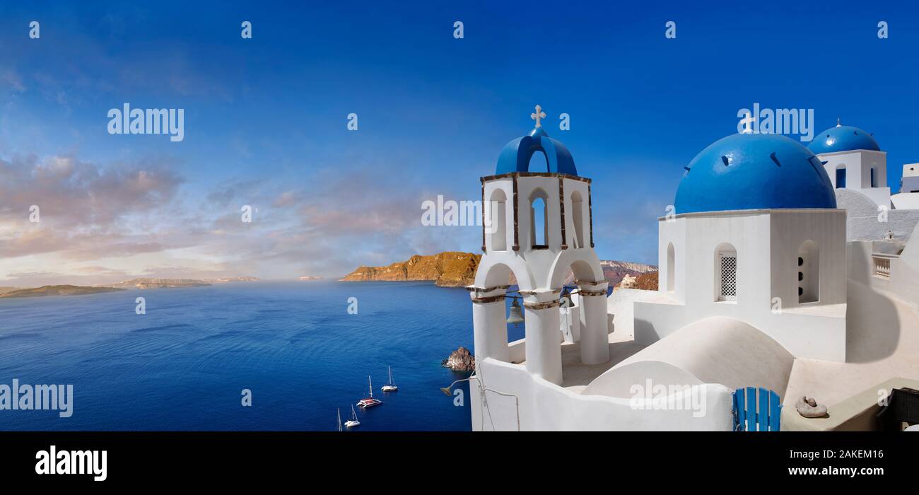 Panoramic  over the traditional Greek Orthodox churches of Oia (ia), Cyclades Island of  Thira, Santorini, Greece.  The settlement of Oia had been men Stock Photo