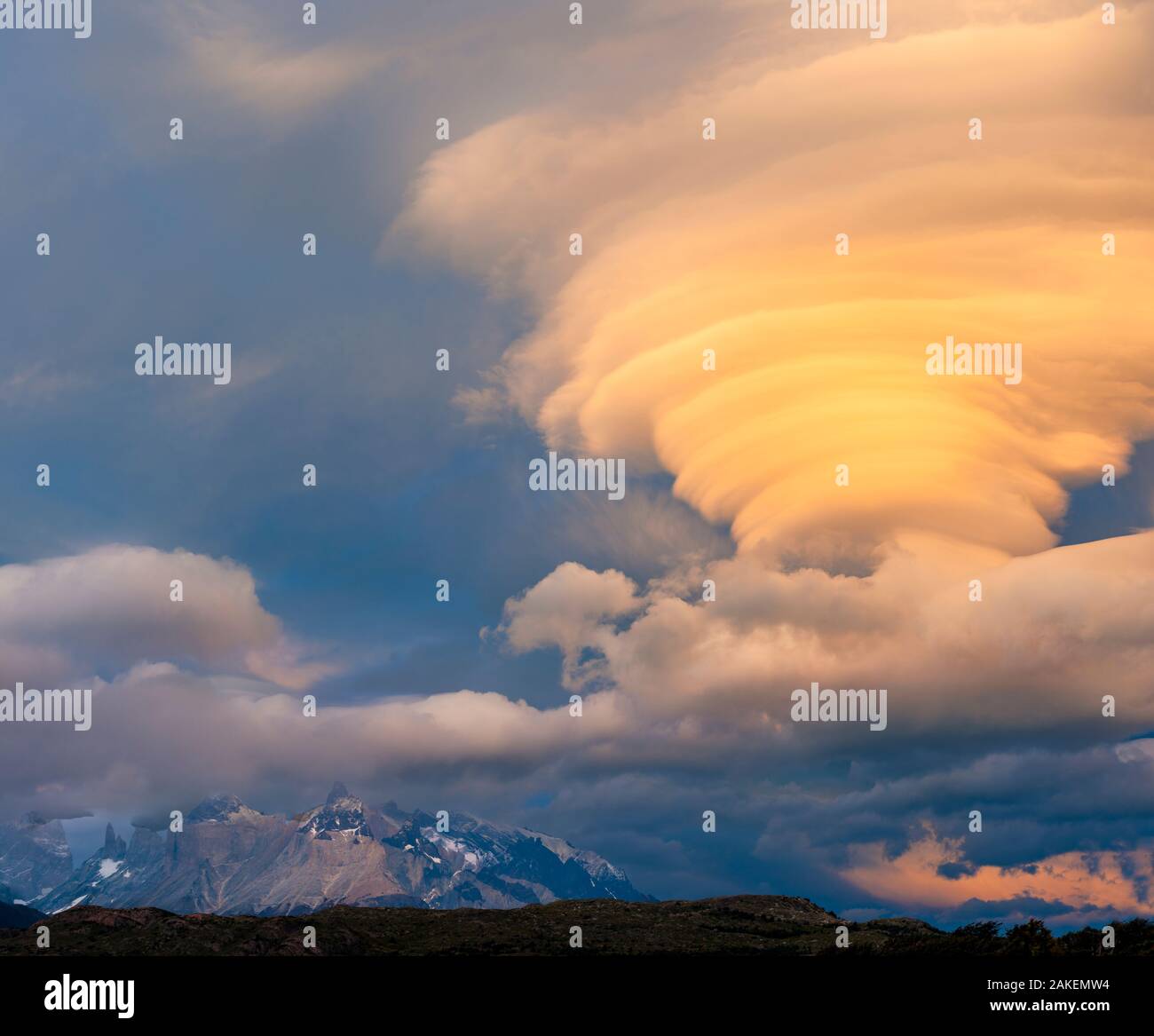 Sunset illuminating lenticular clouds, over Paine Grande, Torres del Paine National Park, Chile. Stock Photo