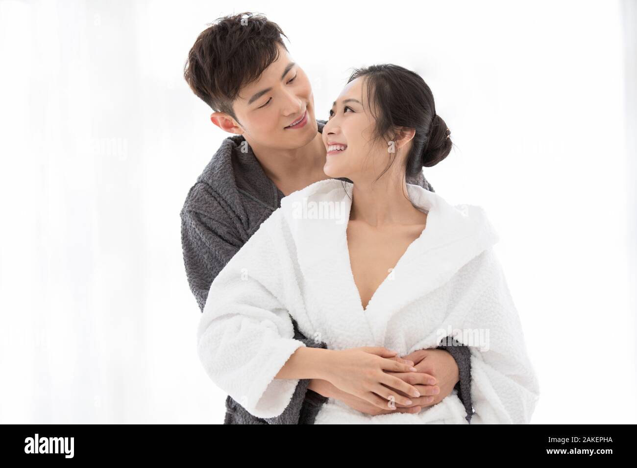 Happy young Chinese couple in bathrobe Stock Photo Alamy