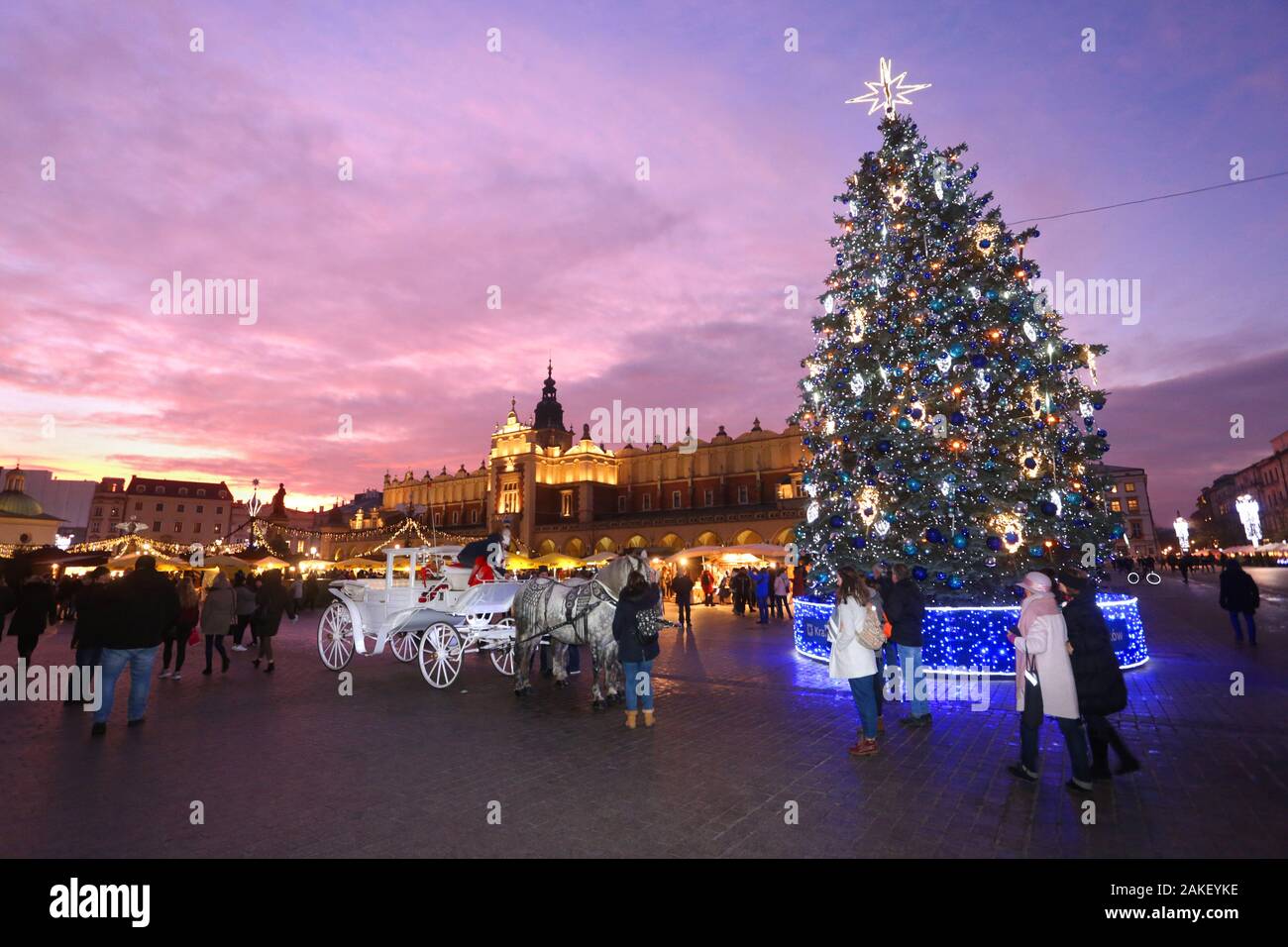 Cracow. Krakow. Poland. Main Market Place, center of the Old Town. Illuminated Christmas Tree under the evening sky. Stock Photo