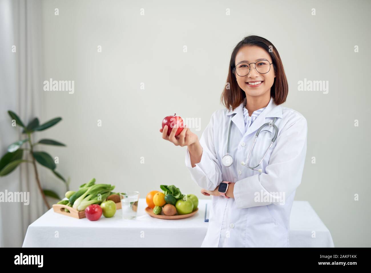 Young asian nutritionist eating an apple hi-res stock photography and ...