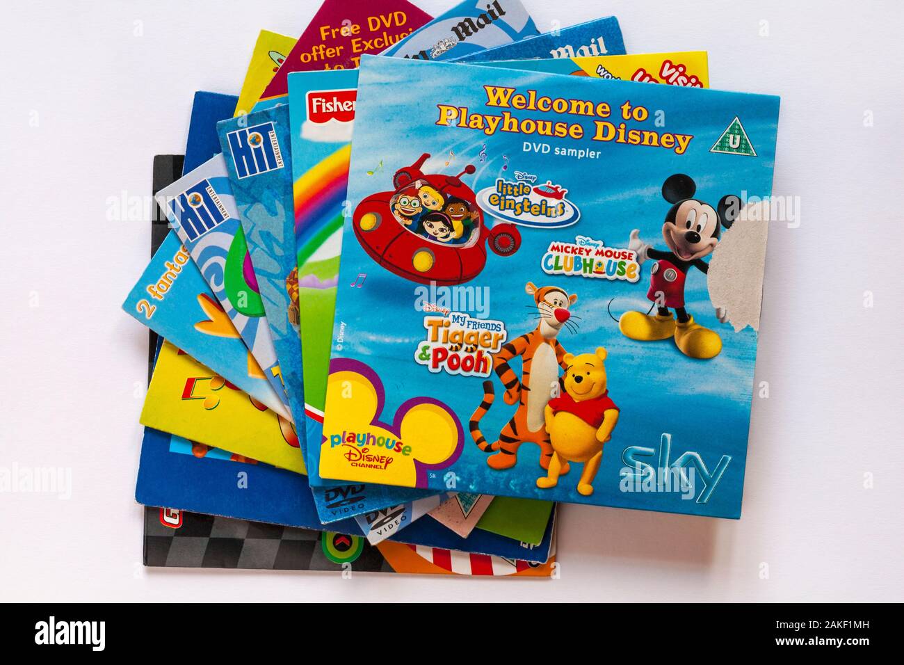 Selection of children's DVDs with Welcome to Playhouse Disney DVD sampler  on top set on white background Stock Photo - Alamy