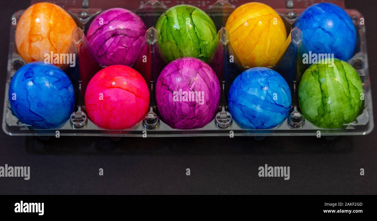 Plastic bowl full of colourful Easter eggs Stock Photo