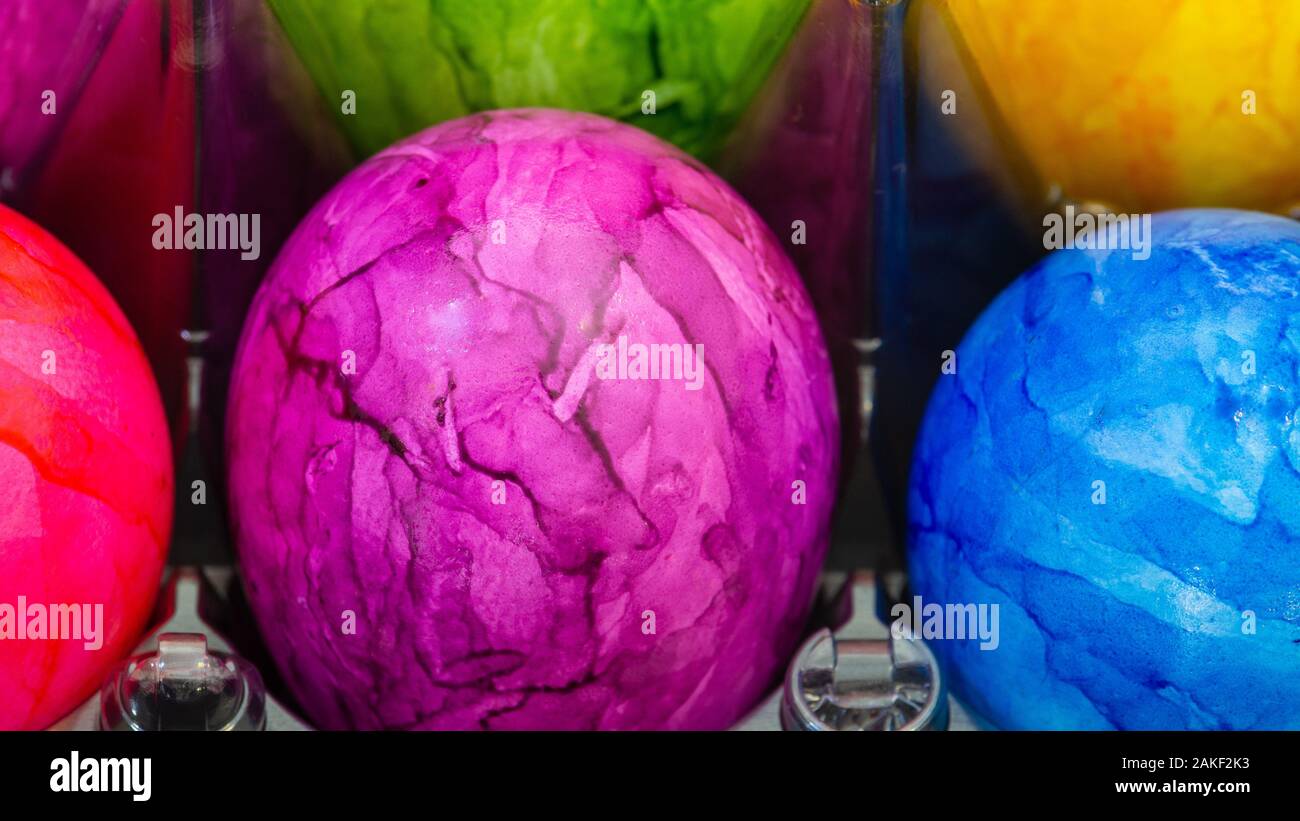 Pink Easter egg in the middle of other Easter eggs Stock Photo