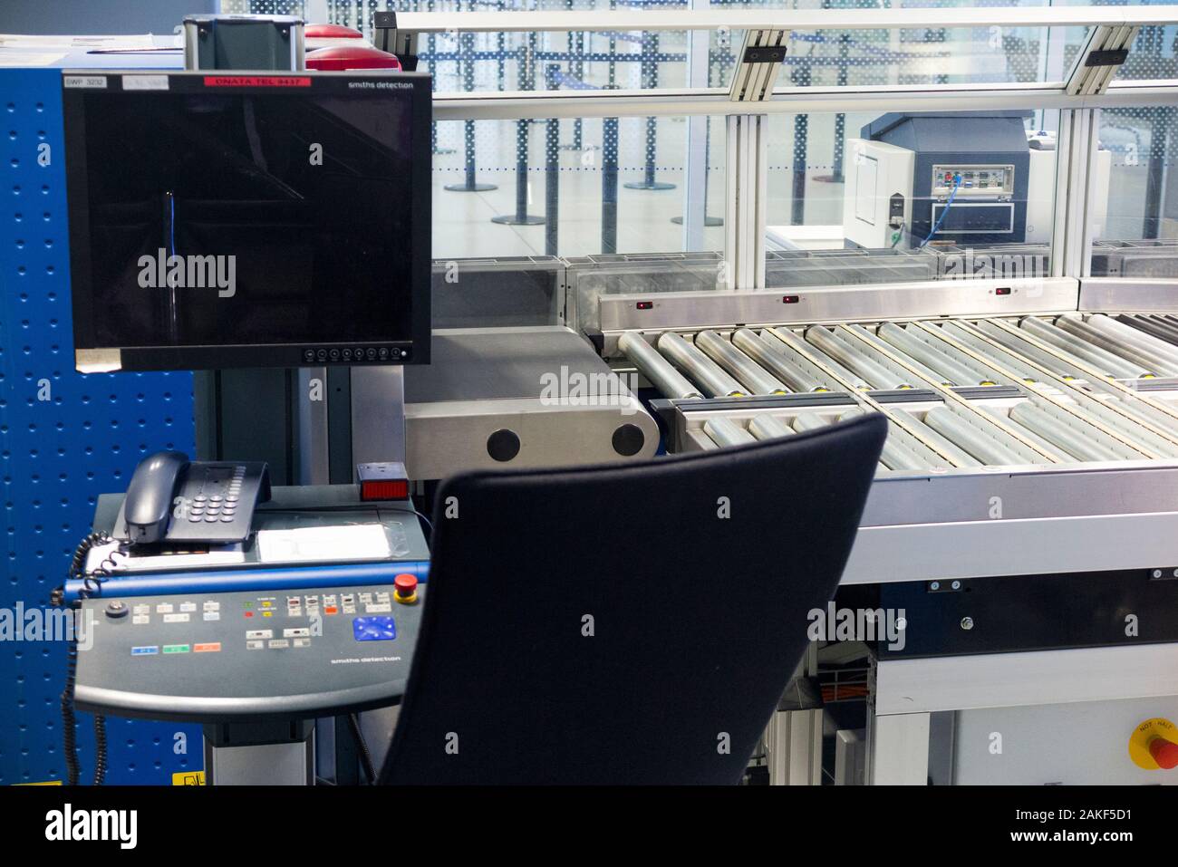 Airport x-ray / X ray security luggage baggage scanner and rollers / rolling belt to transport passengers cases and bags through the machine, made by Smiths Detection. (115) Stock Photo