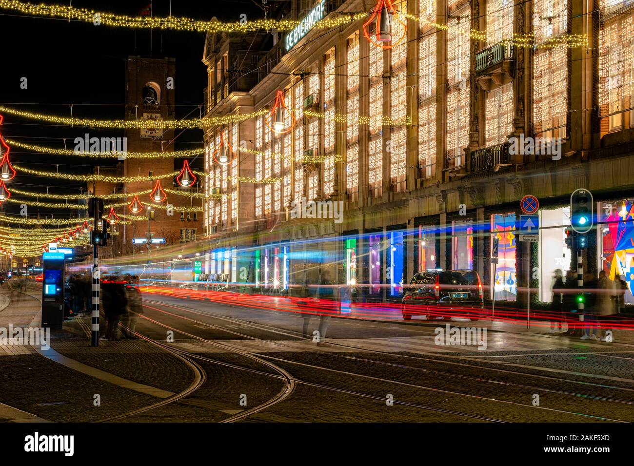 Amsterdam,Netherlands December 23, 2019 : Long exposure light in front of de Bijenkorf shopping mall at night on Dam square in Amsterdam Stock Photo