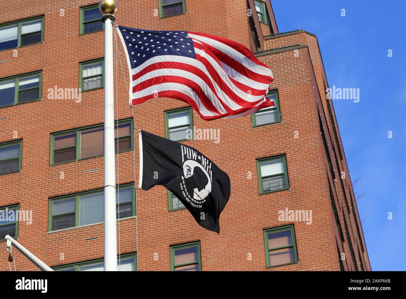 A POW MIA flag flies alongside the American Flag Stock Photo