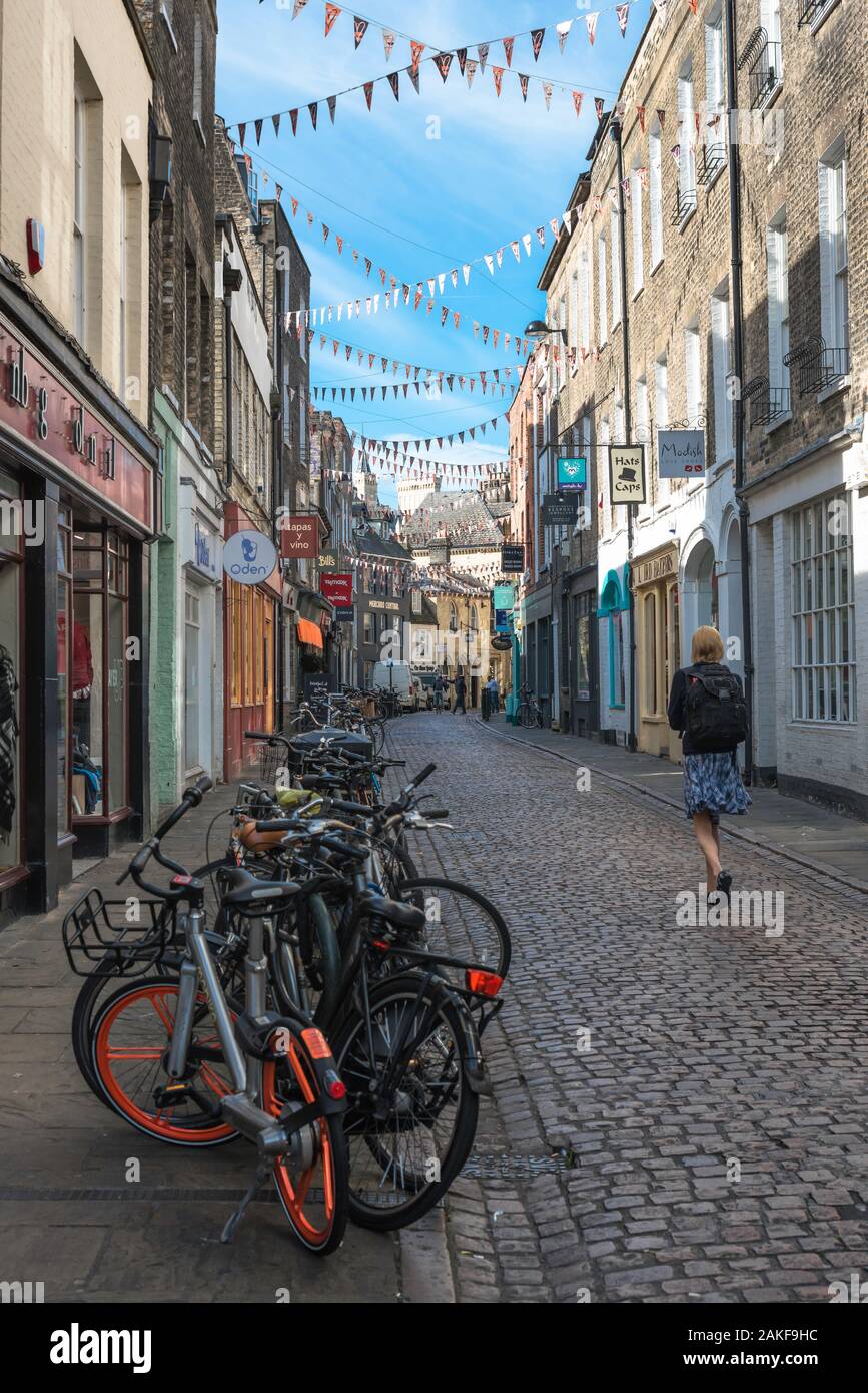 Green Street Cambridge, rear view of a young woman walking along Green Street, a popular shopping street in the university town of Cambridge, England Stock Photo