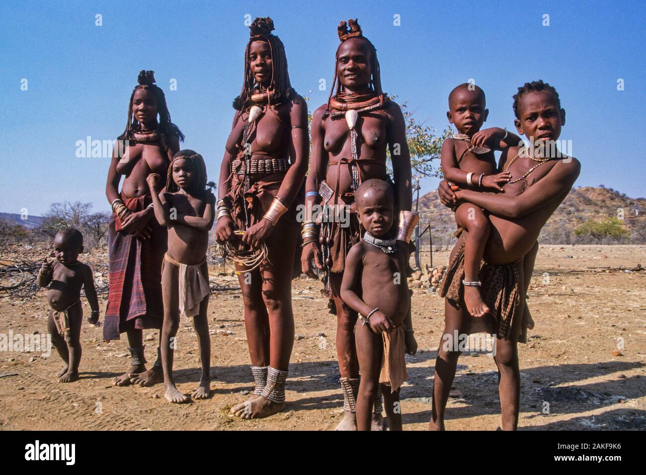 Himba women and children in Kaokoveld, the tribal village Namibia, Africa Stock Photo