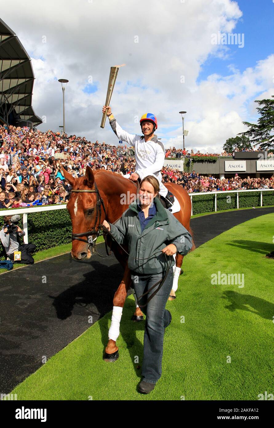 Jockey Frankie Dettori rides ex-racehorse Monsignor to carry the Olympic Flame around the parade ring at Ascot Racecourse, Surrey, as an alternative mode of transport Stock Photo
