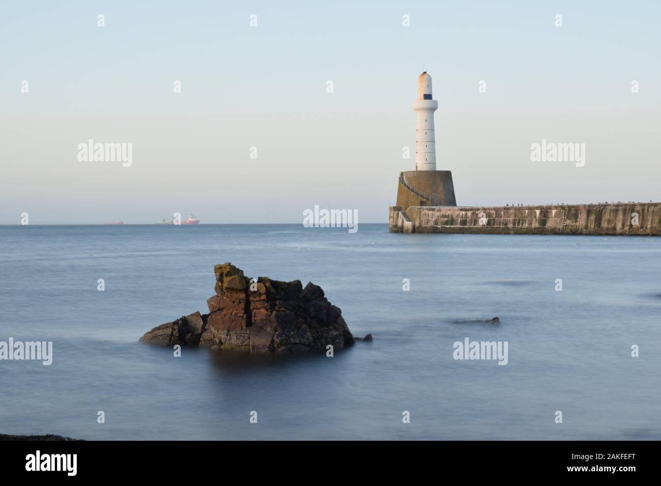Seascape photo of lighthouse at South Breakwater, Aberdeen, Scotland Stock Photo