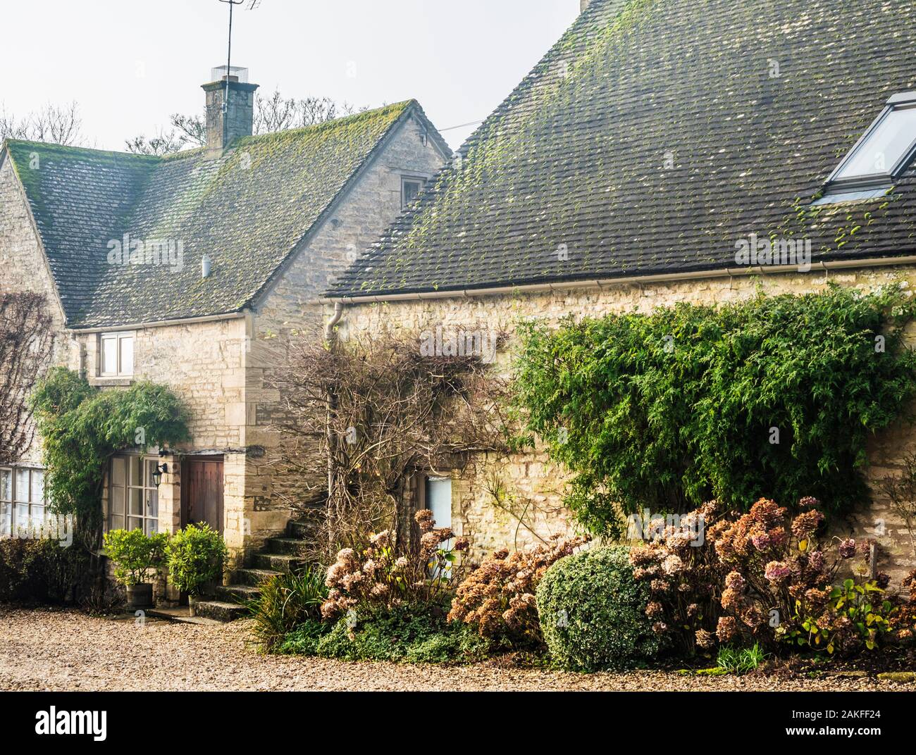 A couple of pretty stone cottages in the Cotswold village of Hampnett in Gloucestershire. Stock Photo
