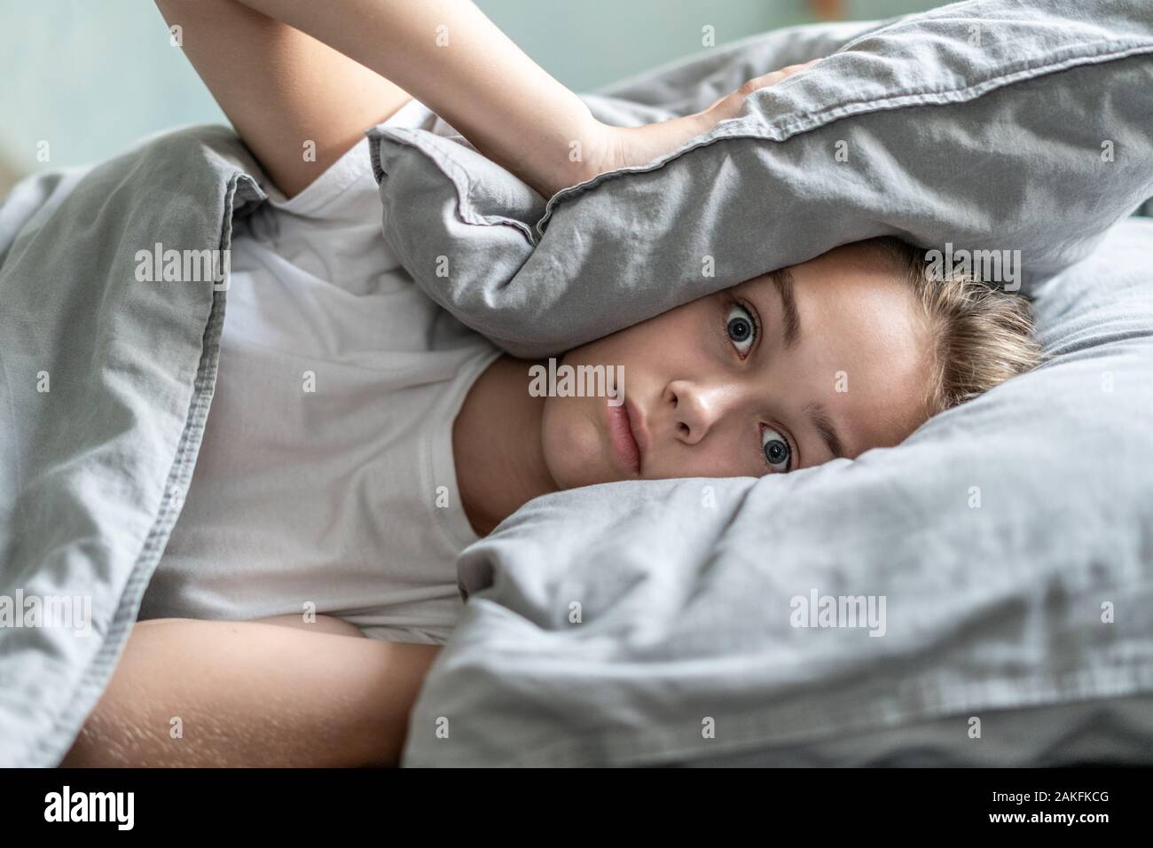 Woman with insomnia lying in bed with open eyes. Early morning hours. Insomnia and sleep problems. Relax and sleep concept. Feels sleepy and tired. Early to get up. Relax and sleep concept. Stock Photo