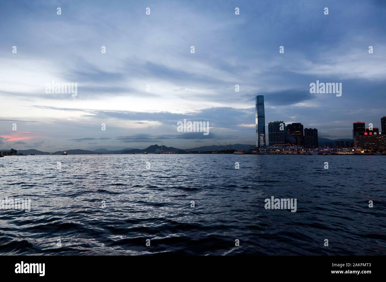 View of Victoria harbour at Sunset looking towards the International Commerce Centre, West Kowloon, Stock Photo