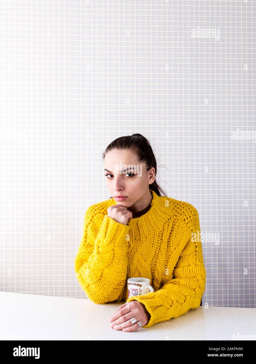 Young woman holding a cup Stock Photo