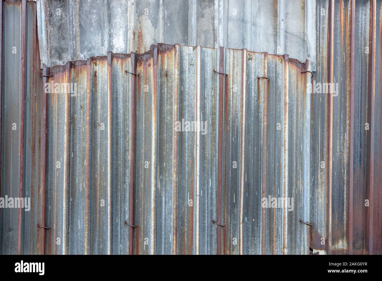 Old rusty sheet metal fence background Stock Photo - Alamy