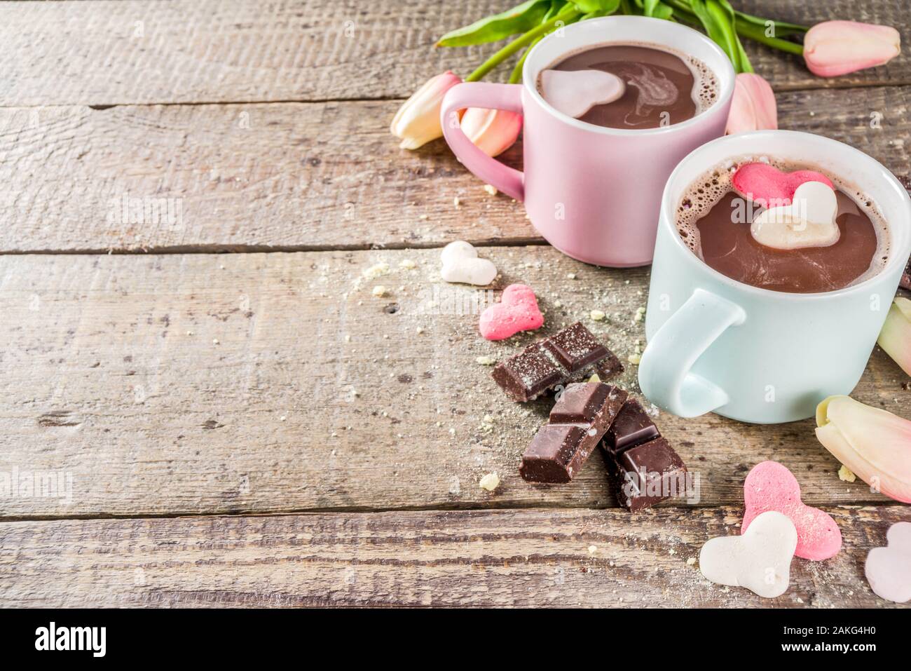 https://c8.alamy.com/comp/2AKG4H0/valentines-day-treat-ideas-two-cups-hot-chocolate-drink-with-marshmallow-hearts-red-pink-white-color-with-chocolate-pieces-sugar-sprinkles-old-wood-2AKG4H0.jpg