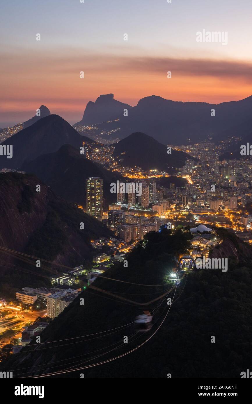 A pink sunset view at dusk over the night street lights of Rio de Janeiro from Sugarloaf Mountain. Stock Photo