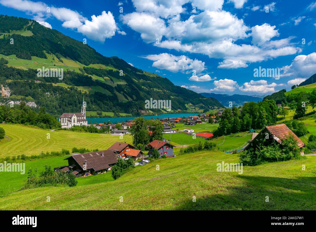 Catholic church, traditional wood and modern houses along the lake