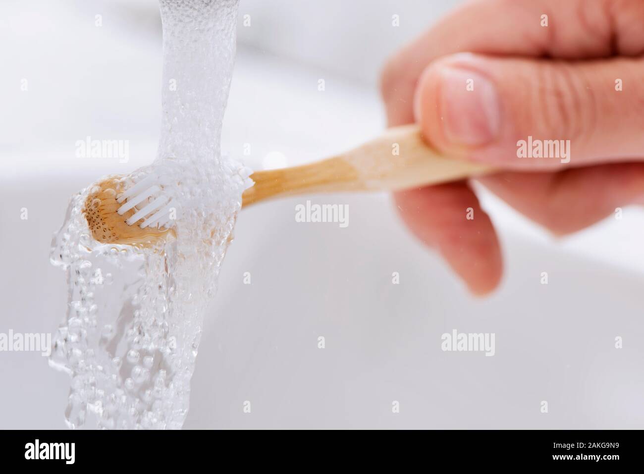 closeup of a caucasian man using a bamboo toothbrush in the bathroom Stock Photo