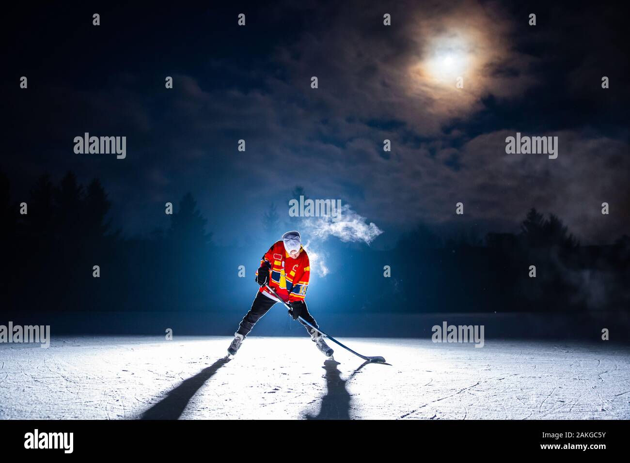 Hockey player concept photo, professional game, edit space, night light Stock Photo Alamy