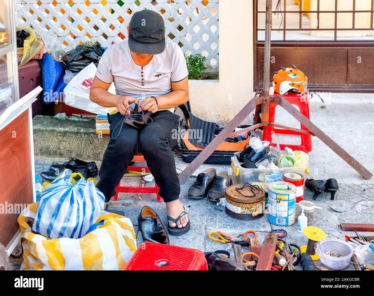 Vietnamese male mending shoes hires stock photography and images Alamy
