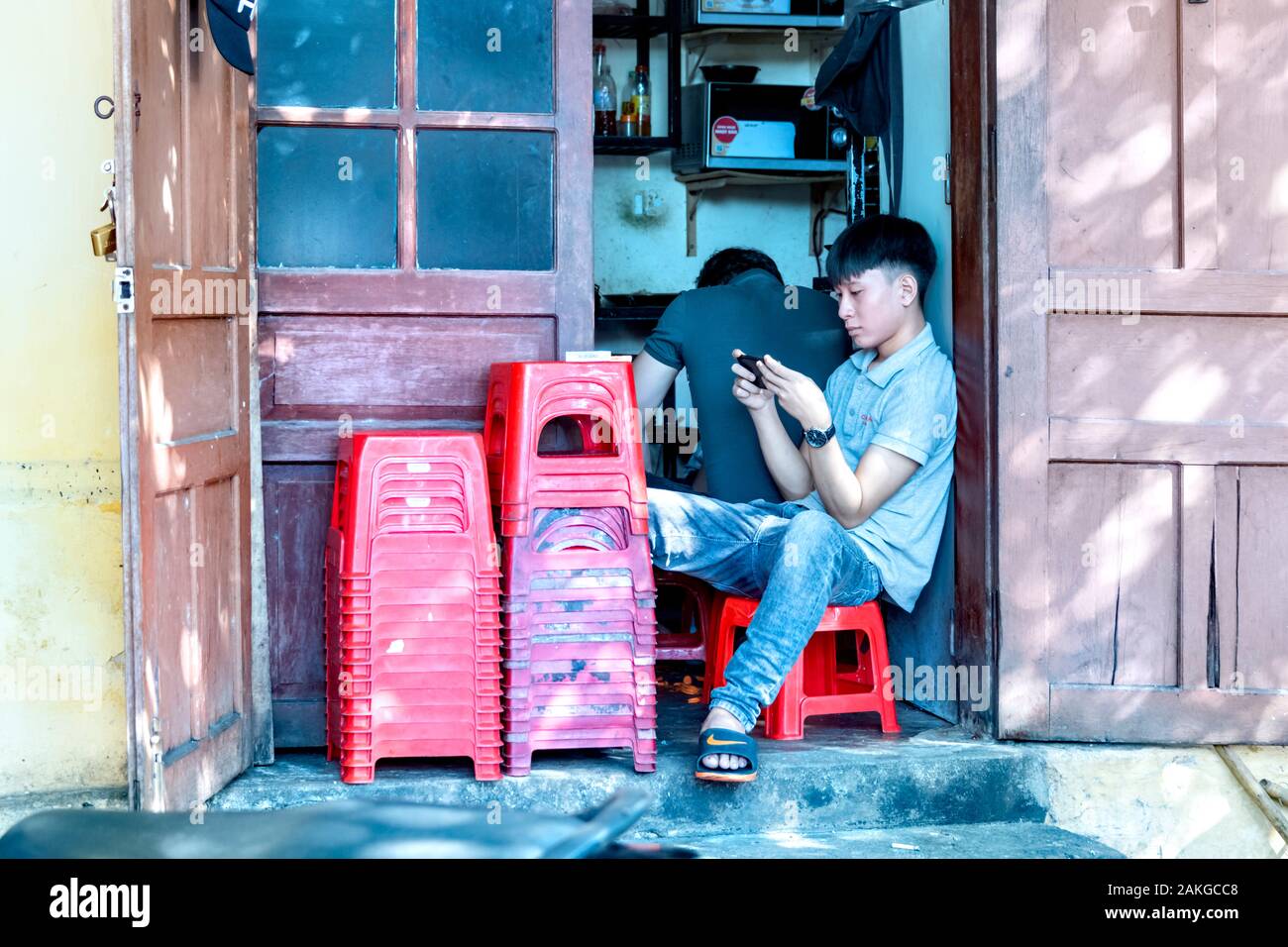 Boy sitting on stool hi-res stock photography and images - Alamy