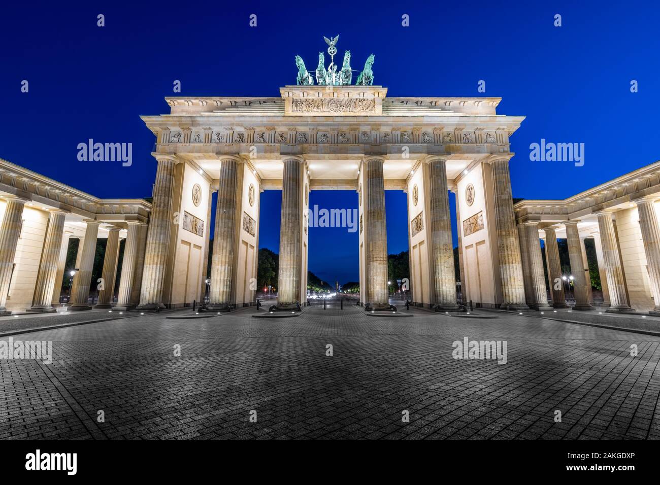 Symmetrical night view of the Brandenburg Gate, against a dark blue sky Stock Photo