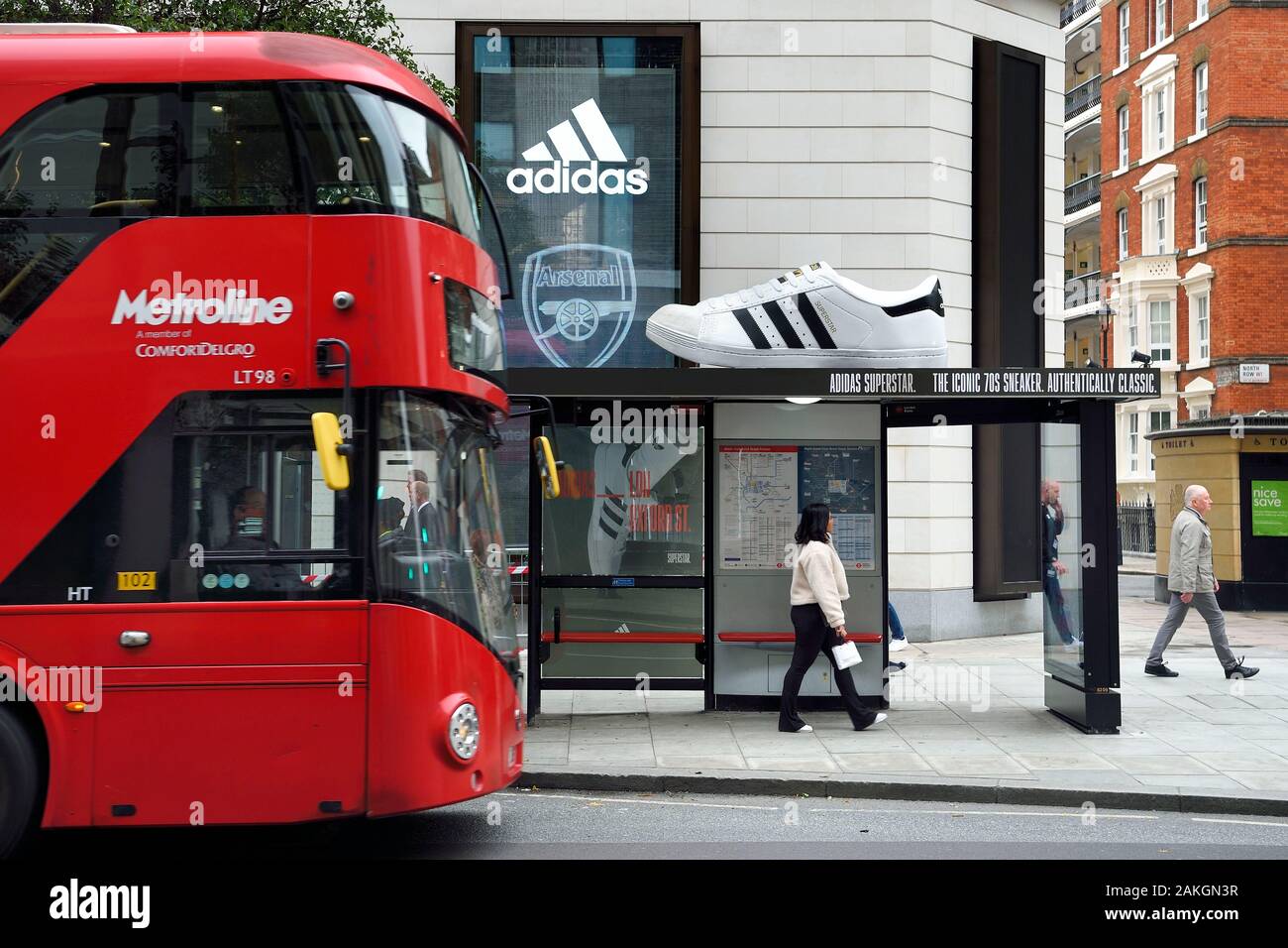 United Kingdom, London, giant shoe perched on a bus shelter for adidas advertising in Oxford street Stock Photo