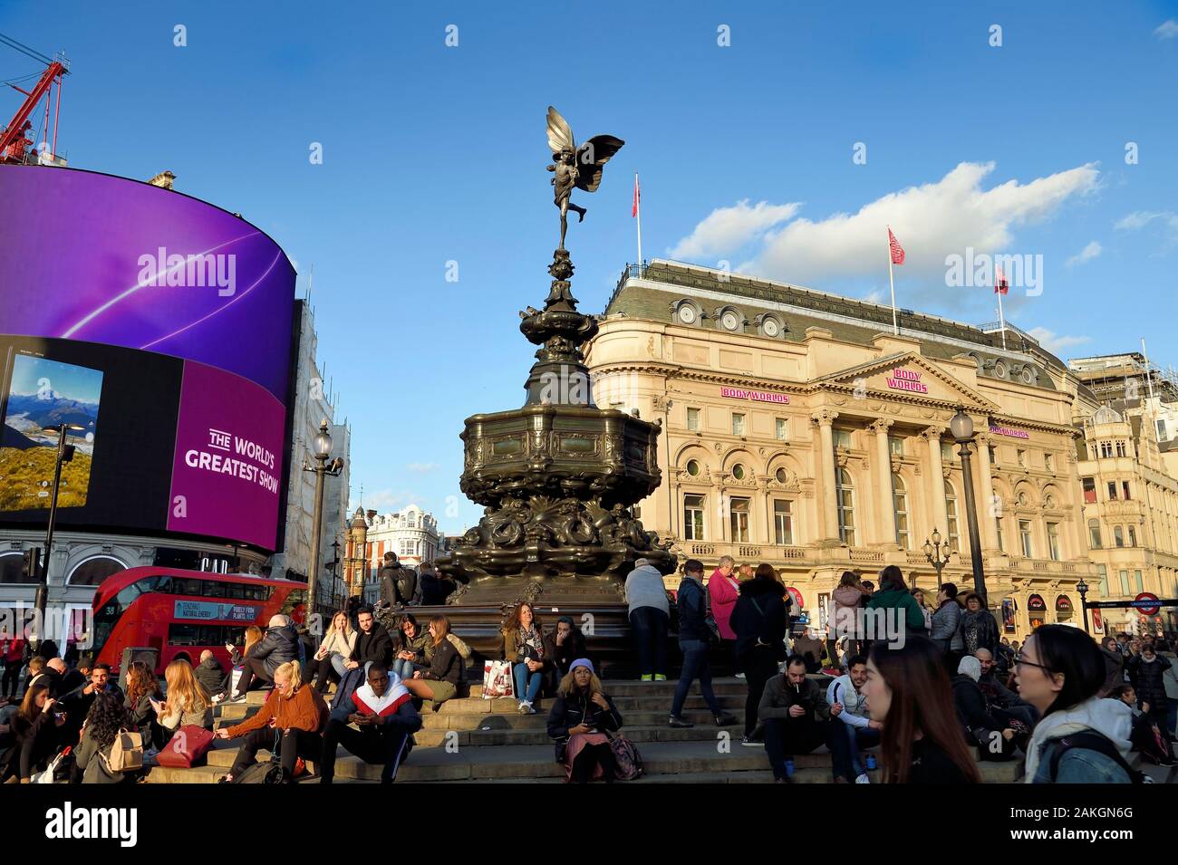 United Kingdom, London, Piccadilly Circus, crowd sitting at the foot of the statue of Eros Stock Photo