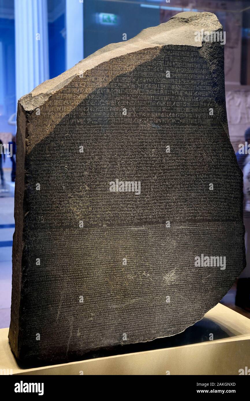 United Kingdom, London, Bloomsbury area, the British Museum, Ancient Egypt, the Rosetta Stone, engraved stela fragment of ancient Egypt bearing three versions (hieroglyphs, Egyptian demotic and Greek alphabet) of the same text that allowed the deciphering of hieroglyphs in the 19th century by Jean-François Champollion Stock Photo