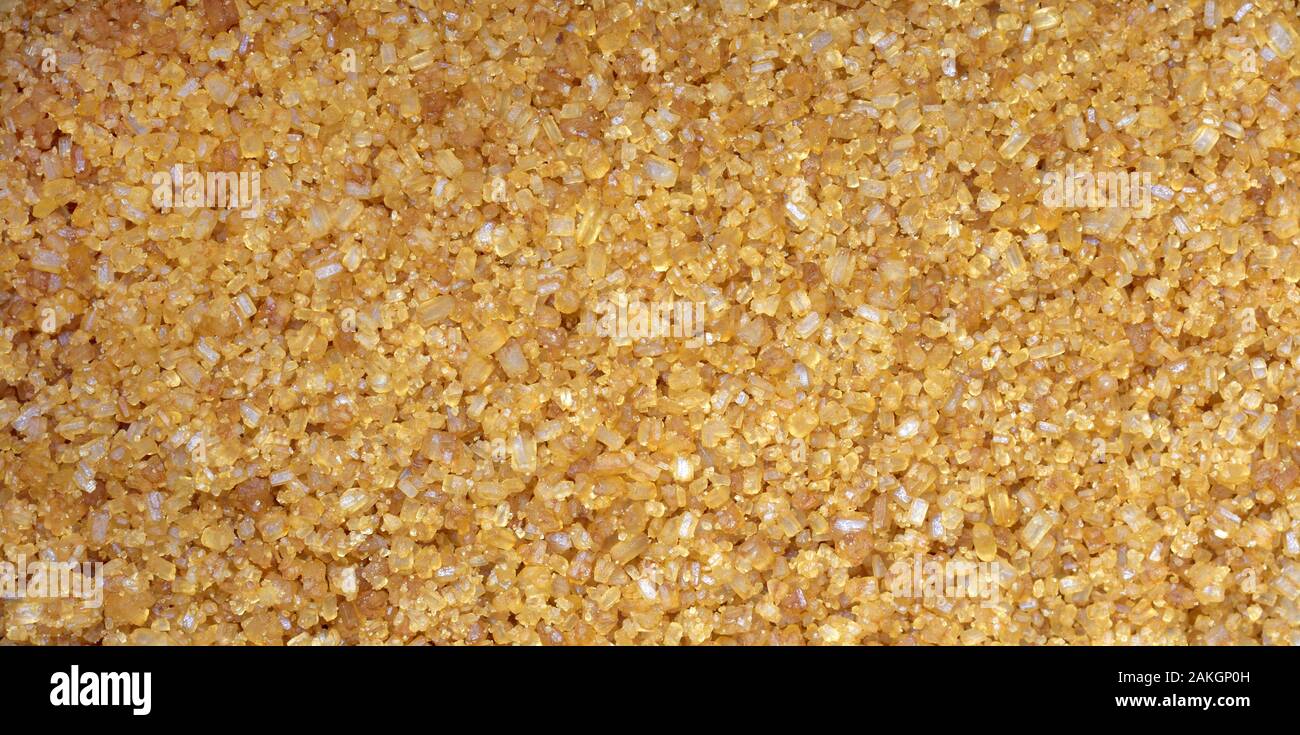 Brown sugar granules, background, close up Stock Photo
