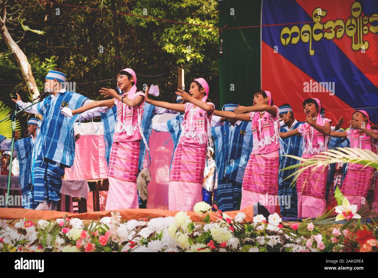 Bilu Kyun, Ogre Island, Mon State, Myanmar - 12 January 2013: Children dancing on stage in traditional burmese dresses on a new year celebration Stock Photo