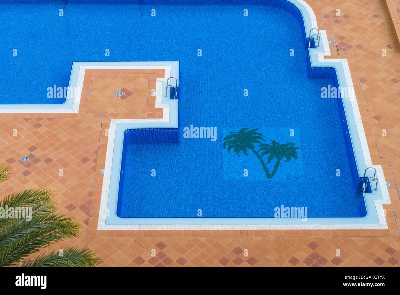 Spain, Canary Islands, Tenerife Island, Playa de Las Americas, elevated view of swimming pool with palms Stock Photo