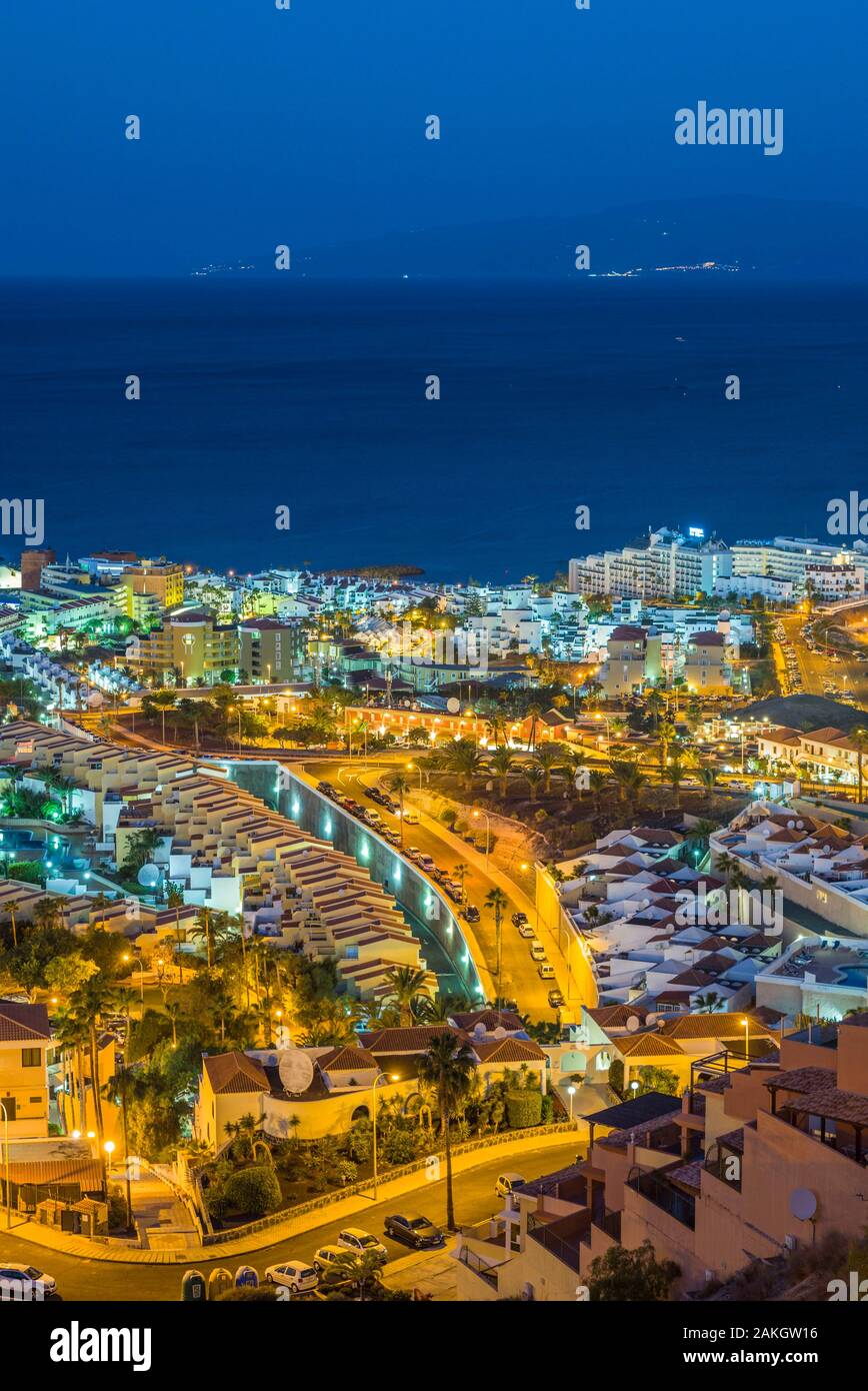 Spain, Canary Islands, Tenerife Island, Playa de Las Americas, elevated resort view with La Gomera Island, dawn Stock Photo