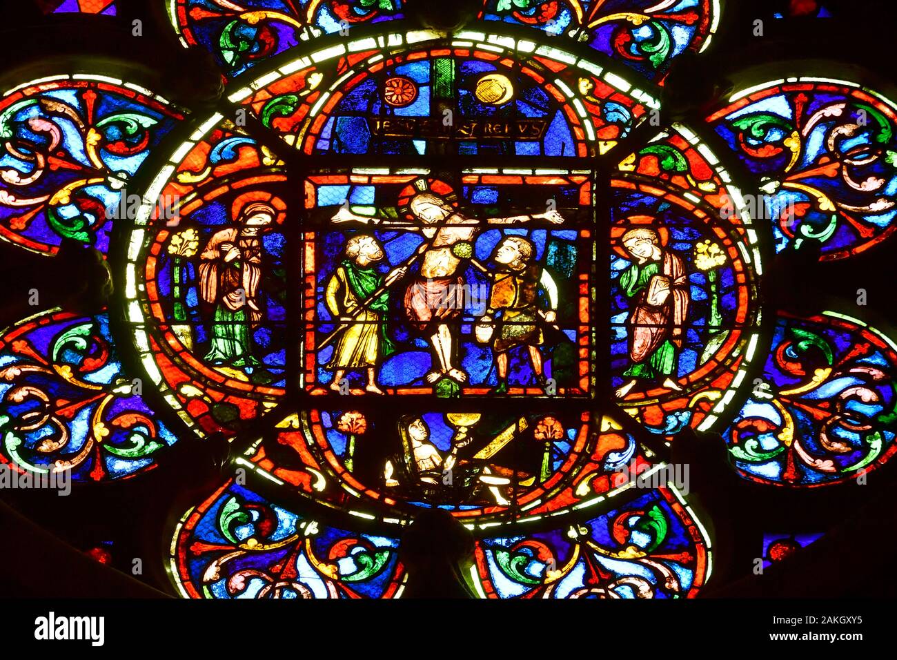 France, Oise, Beauvais, Saint-Pierre de Beauvais cathedral built between the 13th and 16th century has the highest choir in the world (48,5 m), Our Lady (Notre-Dame) or Virgin Chapel, Stained glass from the 13th century, Rose of the Crucifixion, in the center Jesus on the cross is surrounded by 2 soldiers, on both sides Mary, his mother and a disciple, John Stock Photo