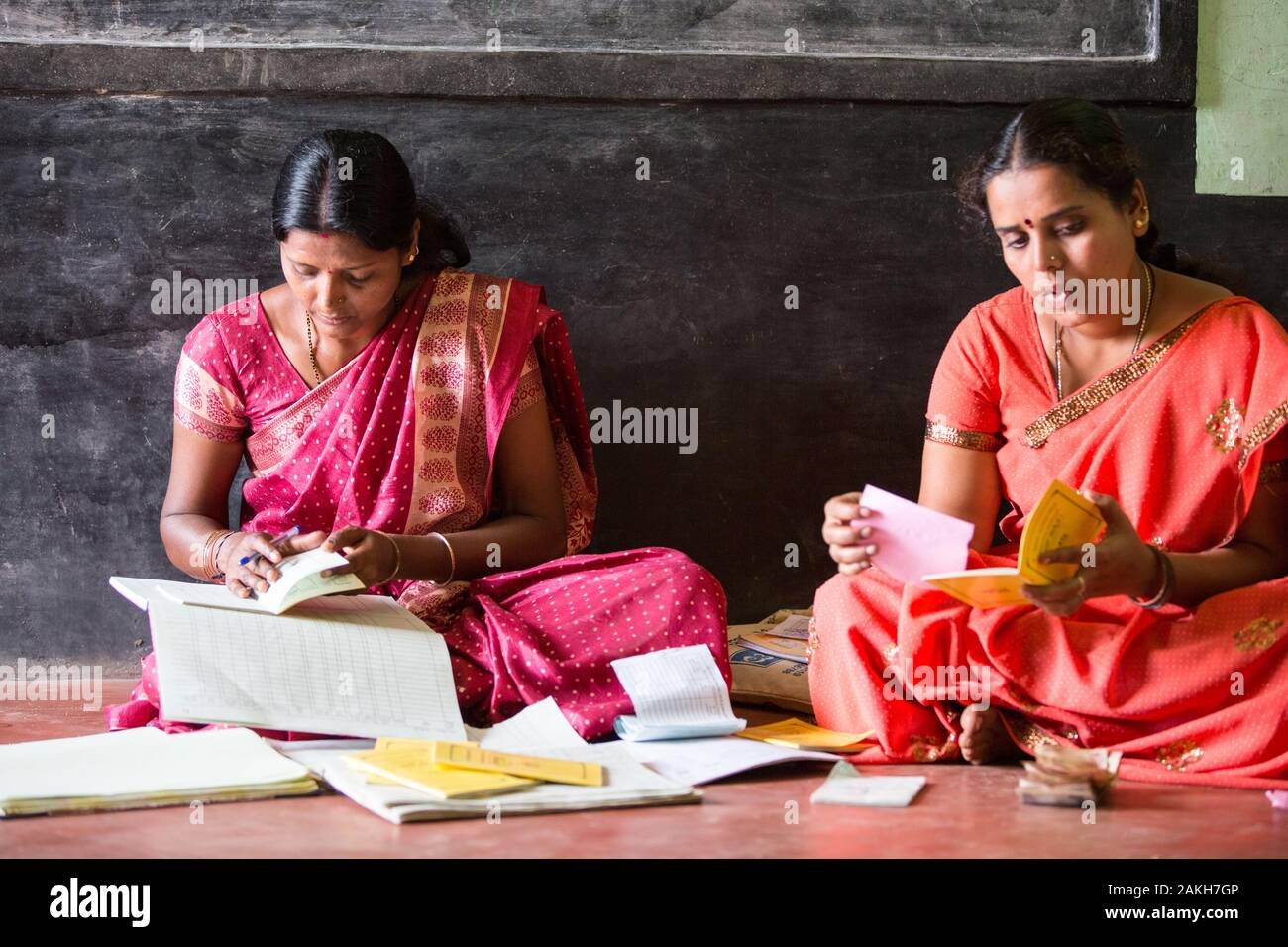 CAPTION: Every self-help group (SHG) has various office-bearing positions, including chairperson (right) and treasurer (left). LOCATION: Doddarayapete Stock Photo