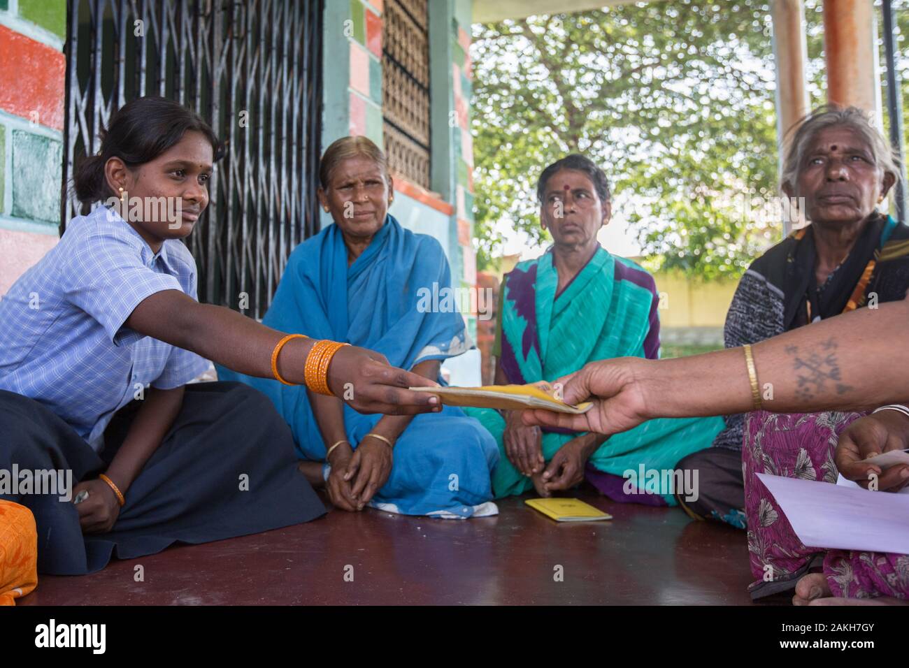 CAPTION: When her mother is unable to attend, Padma stands in for her at their local self-help group (SHG) meetings. This is made up of people from th Stock Photo