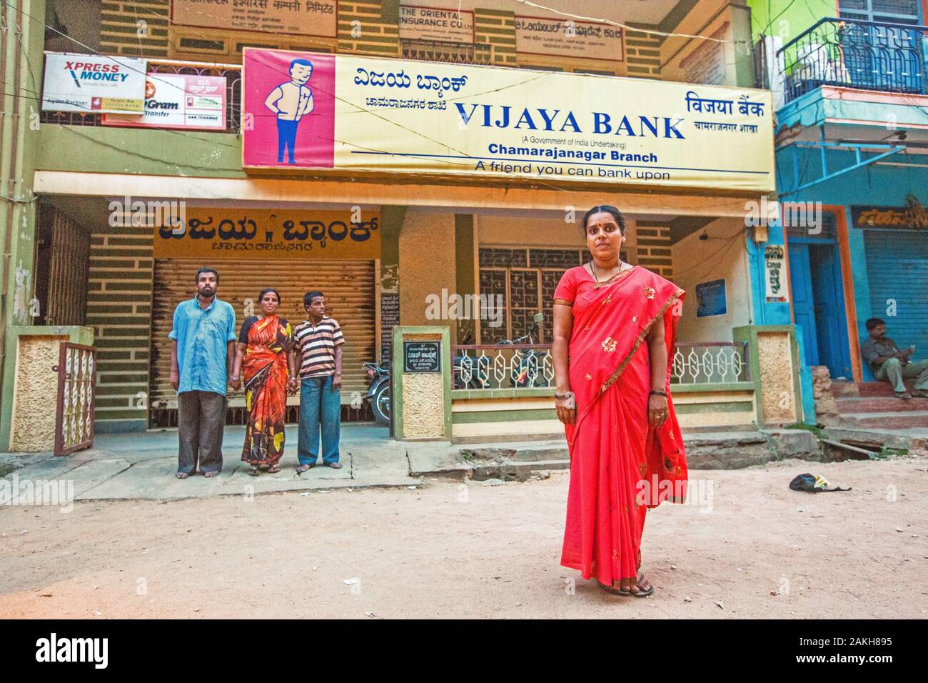 CAPTION: Shobha has taken up a job as a sweeper at Vijaya Bank in order to help support her two brothers, Siddaraju and Shivaraju, who both have sever Stock Photo