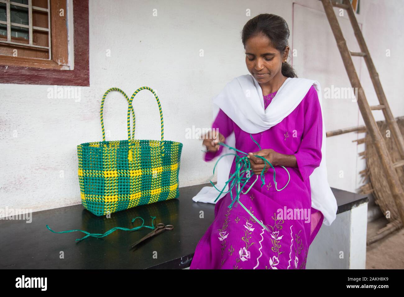 CAPTION: Under the Chamkol programme, every disabled member of the community has an Individual Health Plan (IHP). For Doddamma, this includes basket w Stock Photo