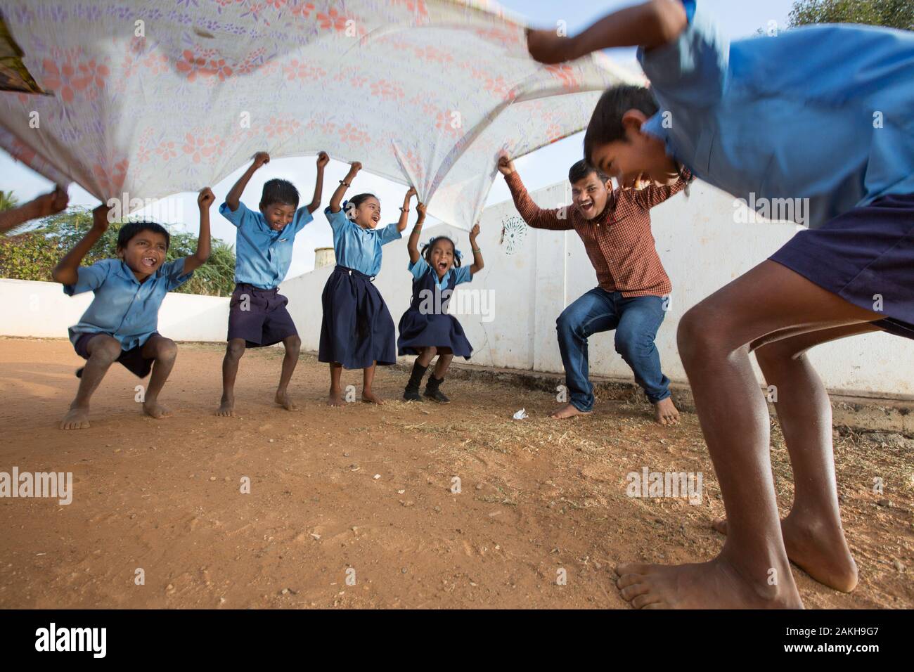 CAPTION: Partially visually impaired After-School Club (ASC) Coordinator Chethankumar leads 'Cheering Up', a highly inclusive exercise that gets the c Stock Photo