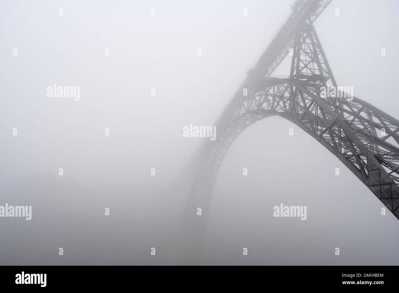 Old iron D. Maria bridge in the fog, Porto, Portugal Stock Photo