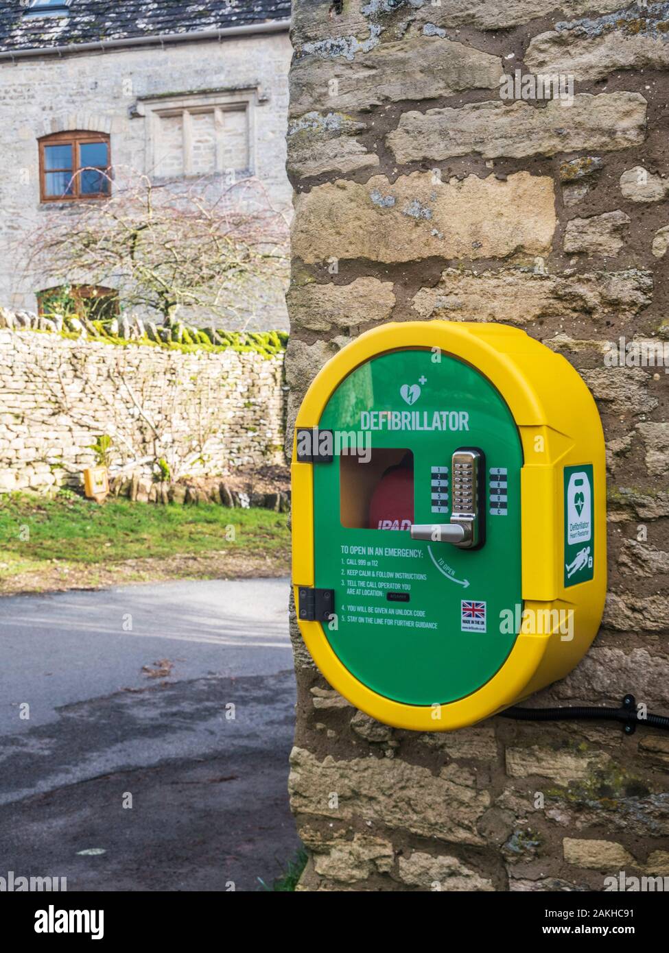 A modern public access defibrillator fixed to a stone wall. Stock Photo