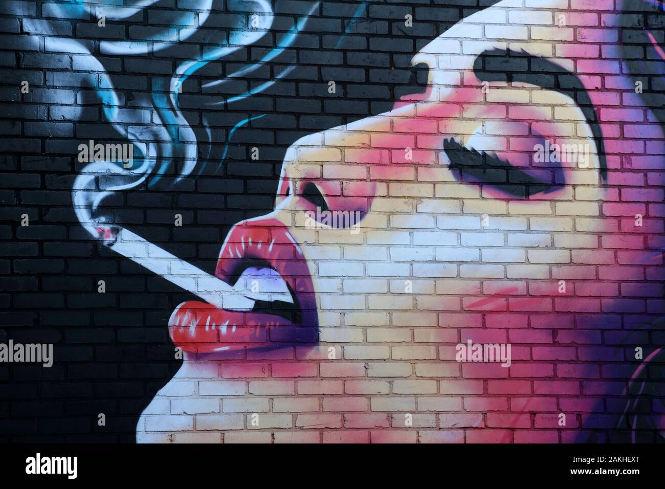 Woman smoking cigarette street art in the Digbeth area of Birmingham,  England, UK Stock Photo
