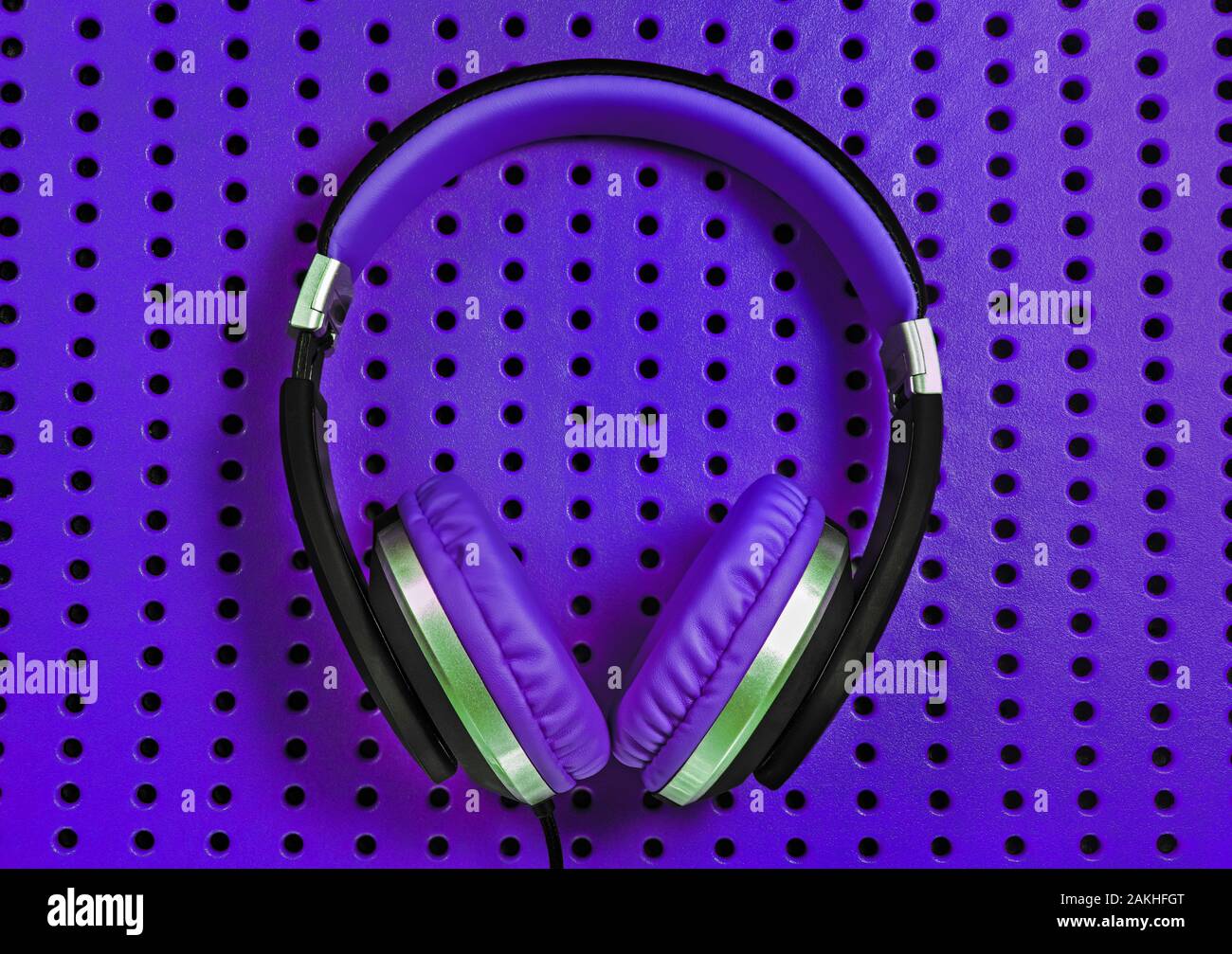Purple headphones on a industrially like, textured purple surface Stock Photo Alamy